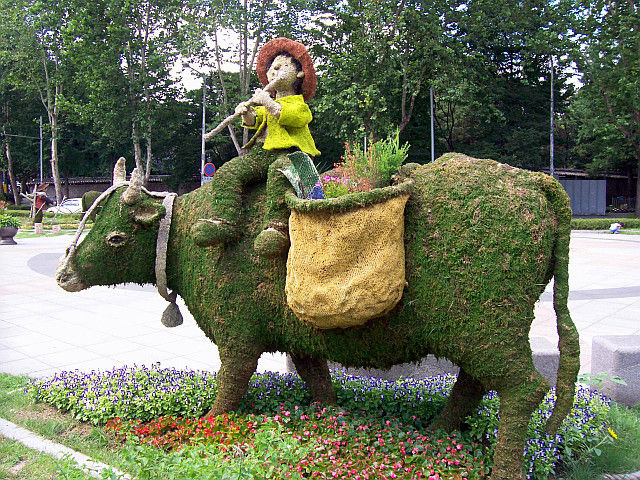 Central Seoul - Sculptures of an ox and a child made with earth and moss